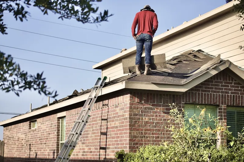 Professional roofer working on a residential roof in Running Fox Estates